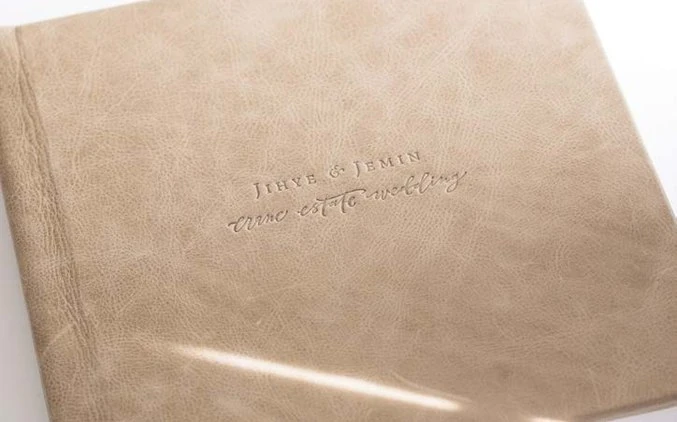 Personal lettering pressed into a warm leather album cover